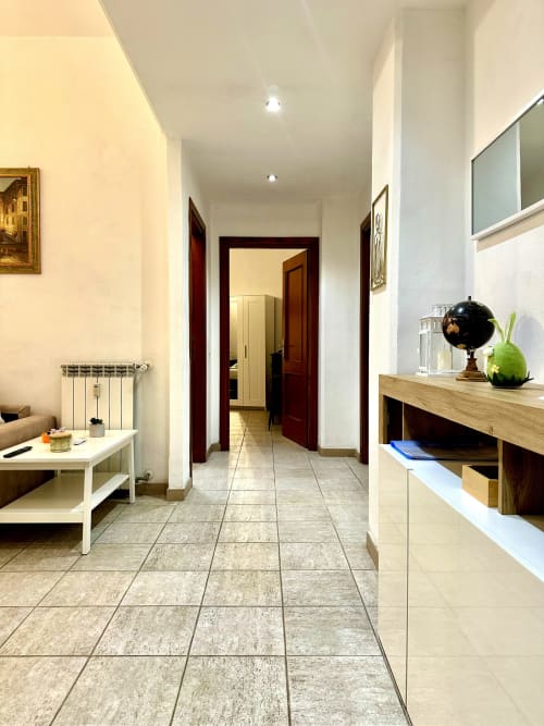 Modern hallway in RomeAntique Stay apartment, Roma with tiled floors, wooden doors, and contemporary furnishings