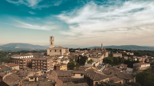 Gualdo Tadino medieval hilltop town in Umbria, Italy with terracotta roofs and cathedral tower, countryside backdrop