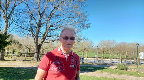 Senior man in red shirt at La Bergerie De Laura, a French countryside B&B in Coeur de Causse, with bare trees and gardens