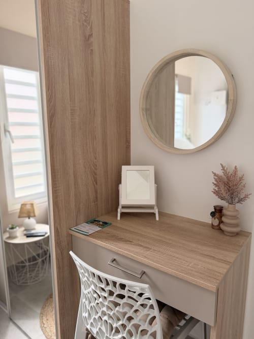 Stylish vanity desk with round mirror at Filao Cottage in Sainte-Rose, Guadeloupe