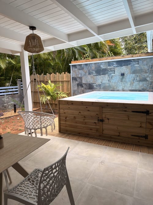 Filao Cottage patio with elevated pool, dining area, and tropical garden in Sainte-Rose, Guadeloupe