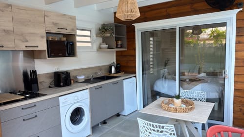 Modern kitchen in Filao Cottage cottage with washing machine, dishwasher, and sliding doors to private patio, Sainte-Rose,