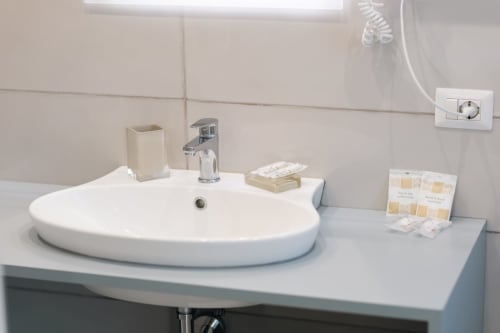 Modern bathroom sink with chrome faucet at L'Amaranto B&B in Agerola, featuring white countertop and amenities