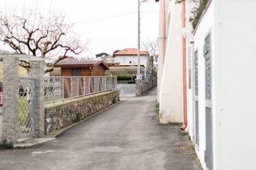 Pathway entrance to L'Amaranto B&B in Agerola with stone walls and bare trees