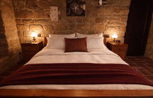 Historic stone bedroom with warm lighting in a medieval fortress