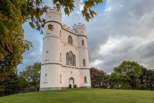 White castle tower on green grounds near Exeter, England - 2 Doves Holiday Property