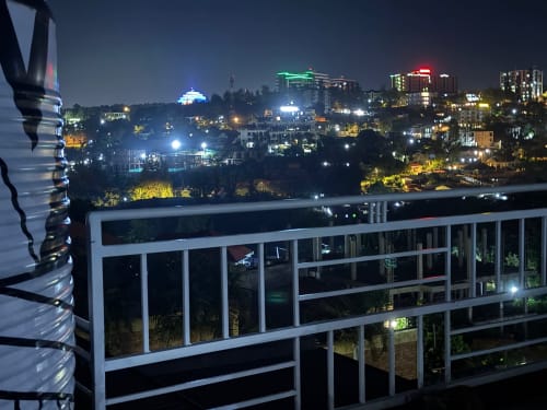 Night view of Kigali cityscape from 650 KGL Place balcony in Remera with illuminated buildings and streets
