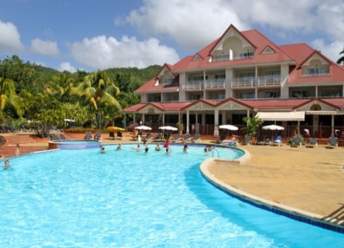 Tropic Appartements à Sainte-Anne, Martinique - piscine courbe avec clients, resort balnéaire avec toit rouge