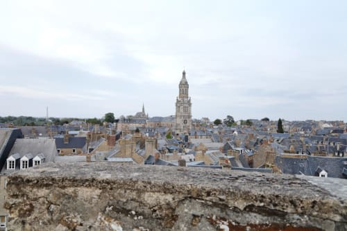 Cholet skyline with church spire and historic stone buildings, Appart'Hôtel France location view