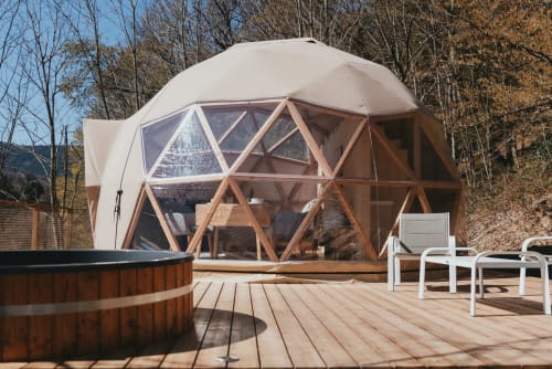 Geodesic dome cottage at Les Cabanes du Nideck with wooden deck, hot tub, and mountain views in Oberhaslach, France