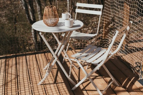White folding furniture set on mountain cottage patio at Les Cabanes du Nideck, Oberhaslach