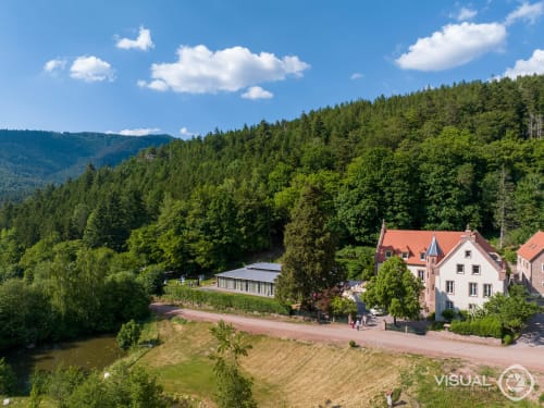 Les Cabanes du Nideck cottage hotel nestled in forested Oberhaslach mountains with river view