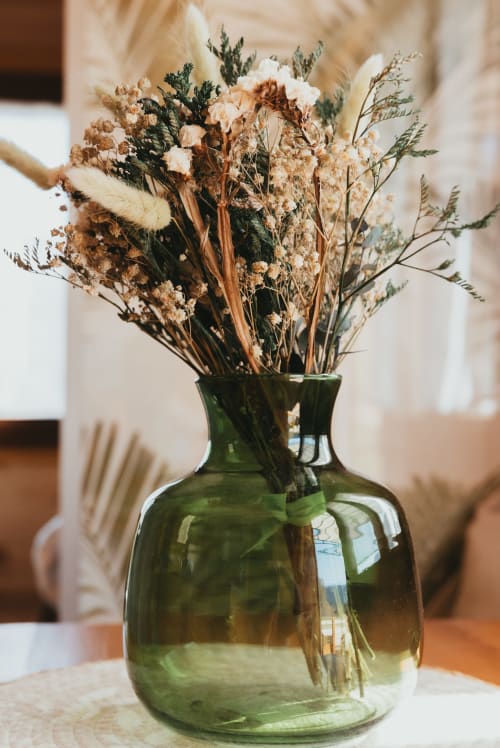 Dried flower arrangement in green glass vase at Les Cabanes du Nideck cottage, Oberhaslach