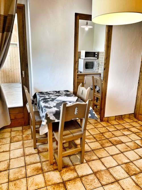 Studio apartment kitchen and dining area at Chez Francine, Notre Dame de Bellecombe with wooden furniture and terracotta
