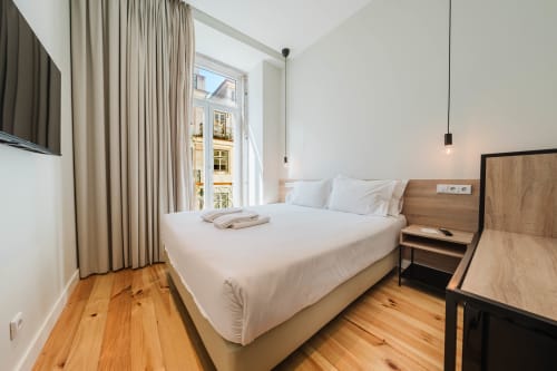 Modern Premium Suite at GS Chiado Boutique Studios in Lisbon with city view, wooden floors, and contemporary furnishings