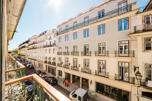 Lisbon city street view from GS Chiado Boutique Studios balcony with historic buildings and parked cars