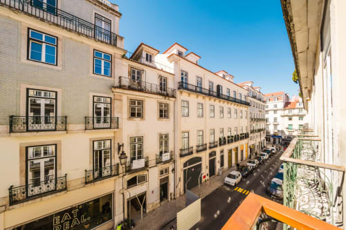 Lisbon street view from GS Chiado Boutique Studios balcony with historic Portuguese buildings and parked cars