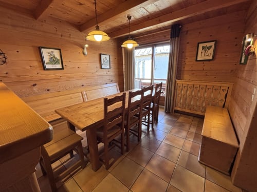Wooden dining room in Chez Marion apartment at Chez Francine, Notre Dame de Bellecombe, with table, chairs, and mountain view
