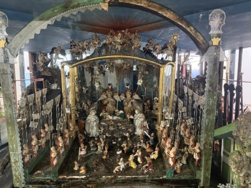 Ornate wooden nativity shrine with gilded details and carved figurines at Golden Mermaid Villa, Ribeirinha