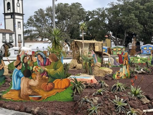 Nativity scene display at Golden Mermaid Villa in Ribeirinha with colorful figures, pumpkins, and tropical plants