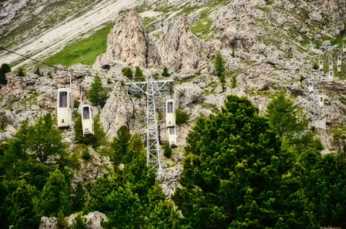 Rustclea Apartments cable car system nestled in dramatic rocky peaks of Selva di Valgardena, Italy