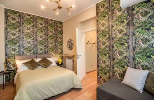 Camera moderna in appartamento Downtown Roma con carta da parati botanica, letto queen e pavimenti in legno