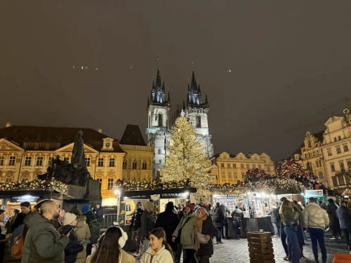 Prague Old Town Square Christmas market with illuminated Church of Our Lady before Tyn and festive crowds