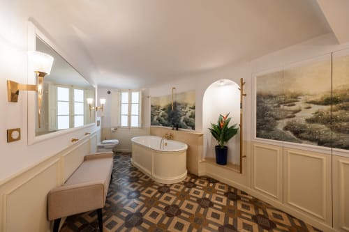 Luxurious bathroom at Les Suites de Montigny, Aix-en-Provence, featuring freestanding tub, dual vanity, and desert artwork.