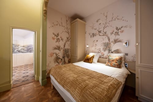 Elegant bedroom at Les Suites de Montigny, Aix-en-Provence with botanical wallpaper, queen bed, and garden view through open