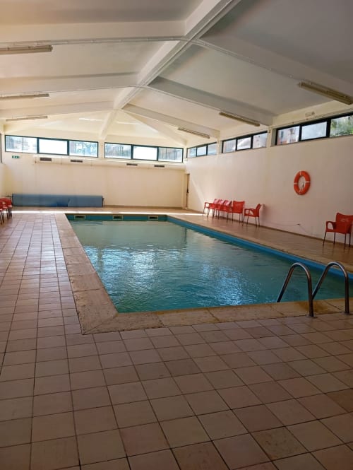 Piscina aquecida coberta do apartamento Sweet Home Paraiso Sol da Rocha em Portimão com área de estar