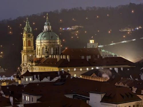 Baroque church with illuminated dome overlooking Ribeirinha at dusk, near Golden Mermaid Villa
