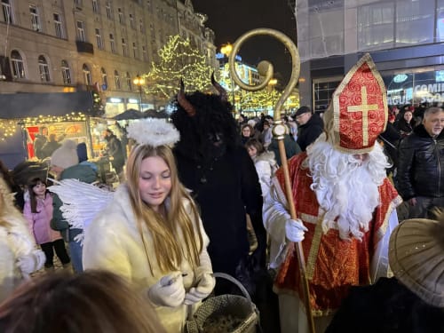 St. Nicholas parade in festive Ribeirinha street with angel costume and holiday decorations