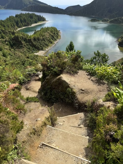 Alpine lake surrounded by evergreen forests and mountains, hiking trail view near Golden Mermaid Villa, Ribeirinha Portugal