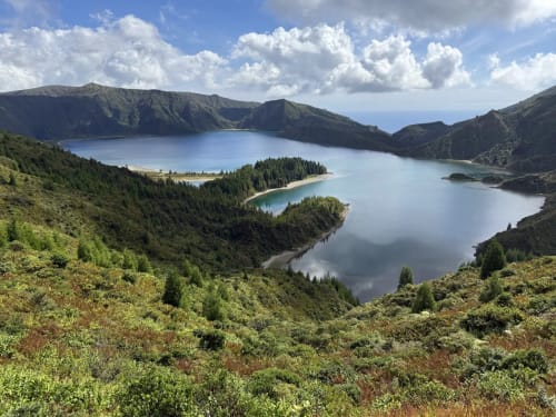 Scenic crater lake surrounded by mountains and forest near Golden Mermaid Villa, Ribeirinha Portugal