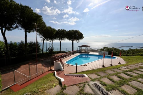 Villa Nella pool area in Lanciano with sea view, furnished terrace, and Mediterranean pines
