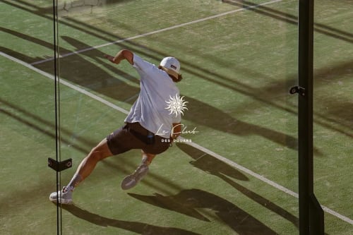 Joueur de tennis en action sur court de terre au Club des Douars près du Riad Eucalyptus, El Ghazouane, Maroc