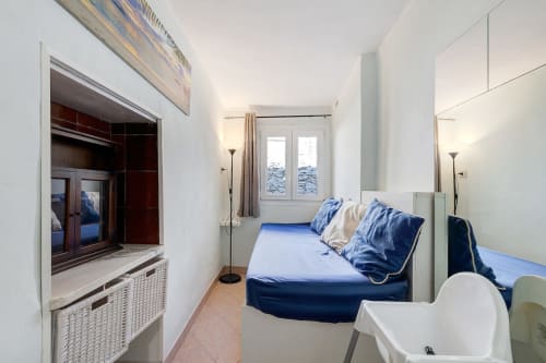 Cozy bedroom at Casa Scola B&B in Loano with double bed, TV, and mirror