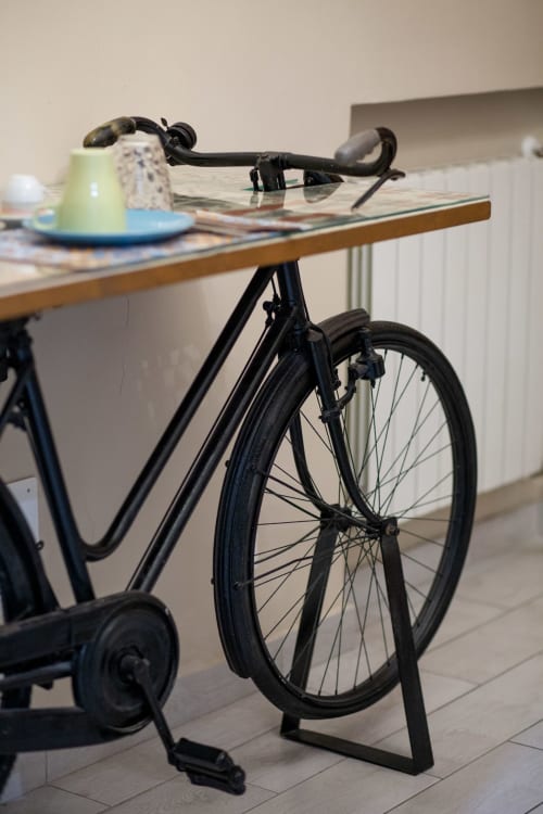 Black road bike with drop handlebars parked indoors at Casa Scola, a bed and breakfast in Loano, Italy