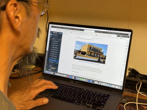 Man viewing Golden Mermaid Villa website on laptop, Ribeirinha Portugal bed and breakfast