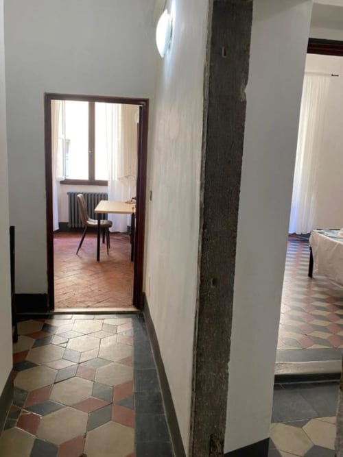 Hallway at Bronze Horse Affittacamere Firenze with geometric tile flooring and doorway to guest room in Florence