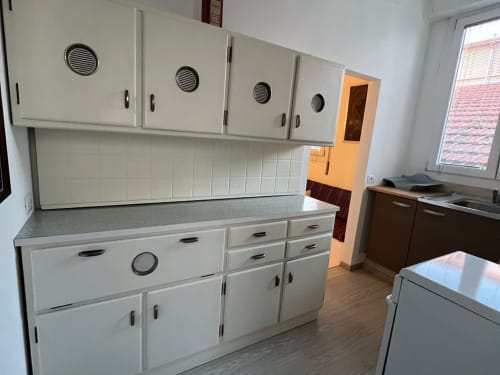 Spacious kitchen in Il Maestrale B&B apartment, Padova, featuring white cabinetry and gray countertops