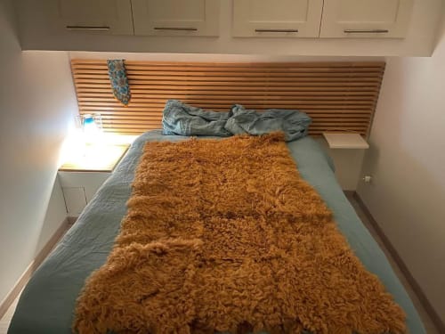 Bedroom in Monolocale 5 at Il Maestrale B&B, Padova, with wooden headboard and terracotta bedspread