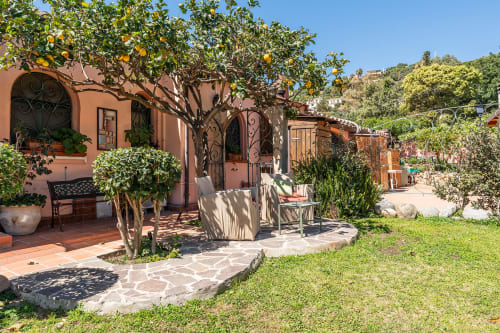 Villa in terracotta con albero di limone, patio in pietra e zona lounge presso Villa Verde a Torre delle Stelle, Italia