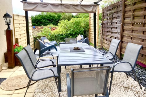 Terrasse de dining extérieure avec table et chaises sous pergola à l'Ô Clair De Lune B&B à Sarlat