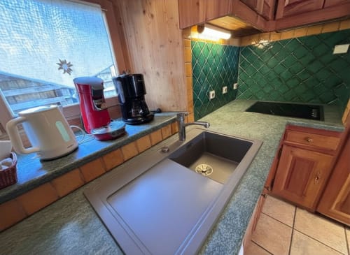 Modern kitchen in Chalet Marie Claire at Chez Francine, Notre Dame de Bellecombe, with mountain views, green backsplash, and