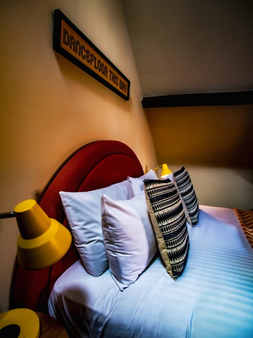 Cozy bed with white pillows and patterned cushions in Historic City Centre Apartment at Stonegate Townhouse, York