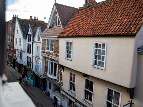 Historic medieval buildings on Stonegate in York city centre, featuring traditional architecture with timber details and