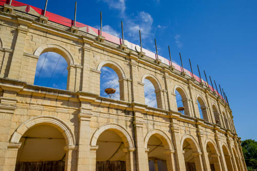 Historic stone building facade with arched openings at Bise de la Jouvence B&B in Saint Laurent sur Sèvre, France
