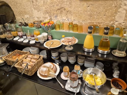 Hôtel Du Cygne breakfast buffet with pastries, breads, juices, jams, and fresh fruit in Tours
