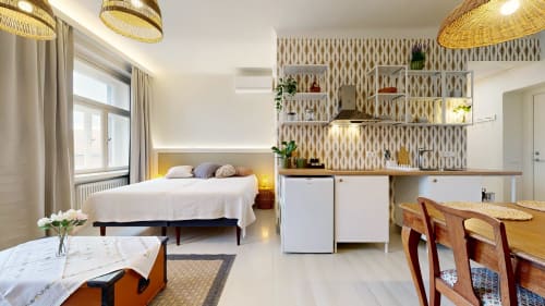 Modern studio apartment at tARTu Stays featuring bed, kitchenette, dining area, and contemporary decor in Tartu city center